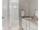Practical bathroom with a single vanity sink, a combination shower and tub, and white tiled floors at 16383 Ute Peak Way, Broomfield, CO 80023