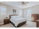 This bedroom boasts a ceiling fan, ample natural light, and neutral paint at 16383 Ute Peak Way, Broomfield, CO 80023