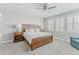 Well-lit bedroom with a ceiling fan, and cozy reading nook offers comfort and style in a tranquil setting at 16383 Ute Peak Way, Broomfield, CO 80023