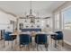 Elegant dining area featuring modern lighting and a seamless transition to the spacious kitchen at 16383 Ute Peak Way, Broomfield, CO 80023