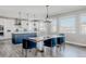 Elegant dining area next to a stunning kitchen and view of the mountains through large windows at 16383 Ute Peak Way, Broomfield, CO 80023