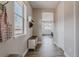 Hallway with a coat rack, bench, and doorway to the kitchen, filled with natural light at 16383 Ute Peak Way, Broomfield, CO 80023