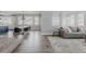 Open-concept living room with hardwood floors, modern furnishings, and abundant natural light, perfect for entertaining guests at 16383 Ute Peak Way, Broomfield, CO 80023
