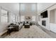 Spacious living room featuring high ceilings, fireplace, large sectional sofa, and lots of windows at 16383 Ute Peak Way, Broomfield, CO 80023