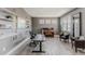 Comfortable home office with shelves, a piano, a modern desk, and leather chairs at 16383 Ute Peak Way, Broomfield, CO 80023