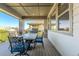 Outdoor patio with wrought iron table and chair set and a grill with a view of the neighborhood at 16383 Ute Peak Way, Broomfield, CO 80023