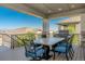 Covered patio with outdoor seating and a grill, perfect for entertaining with mountain views at 16383 Ute Peak Way, Broomfield, CO 80023