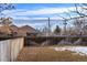 Backyard with wooden fence, distant city views, and patchy snow at 3039 W 22Nd Ave, Denver, CO 80211