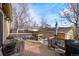 Back deck with seating area, grill, and view of backyard at 3039 W 22Nd Ave, Denver, CO 80211