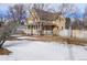 Craftsman home with snowy yard and wooden fence at 3039 W 22Nd Ave, Denver, CO 80211