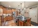 Bright kitchen with wood cabinets, granite countertops, and an island with seating at 3039 W 22Nd Ave, Denver, CO 80211