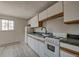 The kitchen features bright white cabinets, a modern faucet, and a white range at 214 N Main St # 14, Breckenridge, CO 80424