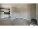 A carpeted living room leading to a kitchen with white cabinets and a brick fireplace at 214 N Main St # 14, Breckenridge, CO 80424