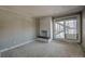 Living room featuring a fireplace, carpeted flooring, and a sliding glass door to the exterior at 214 N Main St # 14, Breckenridge, CO 80424