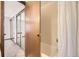 Hall bathroom featuring a shower-tub and bedroom view at 2777 E Geddes Ave, Centennial, CO 80122