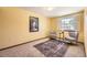 Cozy bedroom with a decorative rug and sitting area by the window at 2777 E Geddes Ave, Centennial, CO 80122