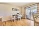 Bright dining room with wood floors, a dining table with seating for six, and sliding glass doors at 2777 E Geddes Ave, Centennial, CO 80122