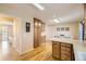 Bright kitchen with wood floors, wooden cabinets, countertops, and an adjacent dining area at 2777 E Geddes Ave, Centennial, CO 80122