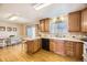 Well-lit kitchen featuring wood floors, countertops, wooden cabinets, and a dining area at 2777 E Geddes Ave, Centennial, CO 80122