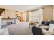 Bright living room featuring a bay window, stairway, and neutral decor at 2777 E Geddes Ave, Centennial, CO 80122