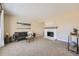 Cozy living room featuring neutral walls, plush carpet, and a charming white brick fireplace at 2777 E Geddes Ave, Centennial, CO 80122