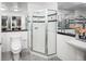 Bathroom featuring glass shower with black and grey tiles, toilet and sink at 1499 Blake St # 6A, Denver, CO 80202