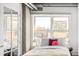 Cozy bedroom with city view, featuring a large window and comfortable furnishings at 1499 Blake St # 6A, Denver, CO 80202