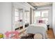 Bright bedroom featuring hardwood floors, a zebra rug, and a large window at 1499 Blake St # 6A, Denver, CO 80202