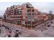 A full exterior of a stunning brick apartment building shows the beautiful architectural design and street view at 1499 Blake St # 6A, Denver, CO 80202