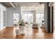 Bright and airy living room featuring hardwood floors, white furniture, concrete ceilings and expansive windows at 1499 Blake St # 6A, Denver, CO 80202