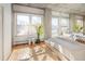 Bright bedroom featuring hardwood floors, concrete accent walls and large windows with city views at 1499 Blake St # 6A, Denver, CO 80202