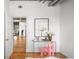 Stylish room with hardwood floors, a glass desk and pink chair at 1499 Blake St # 6A, Denver, CO 80202