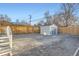 Spacious gravel backyard with a storage shed and secure wooden fencing, ideal for outdoor activities at 722 Kimbark St, Longmont, CO 80501