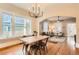 Open dining area with hardwood floors, a modern chandelier, and an open floor plan to the living room at 722 Kimbark St, Longmont, CO 80501