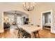 Charming dining room with hardwood floors, an elegant chandelier, and an open layout to living spaces at 722 Kimbark St, Longmont, CO 80501