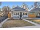 Charming home featuring many windows, tidy landscaping, and a walkway to the front door at 722 Kimbark St, Longmont, CO 80501