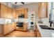 Bright kitchen features stainless steel appliances, light wood cabinets, and white backsplash at 722 Kimbark St, Longmont, CO 80501