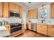 Bright kitchen features stainless steel appliances, light wood cabinets, and white backsplash at 722 Kimbark St, Longmont, CO 80501