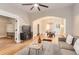 Inviting living room with hardwood floors, a large ceiling fan, and an open layout to the dining area at 722 Kimbark St, Longmont, CO 80501