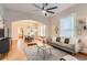 Cozy living room featuring hardwood floors, neutral tones, modern furnishings, and seamless flow to dining area at 722 Kimbark St, Longmont, CO 80501