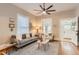 Bright living room featuring hardwood floors, neutral tones, large windows and seamless flow to other rooms at 722 Kimbark St, Longmont, CO 80501