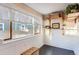 Bright sunroom featuring large window, natural light, decorative shelving, and wooden accents at 722 Kimbark St, Longmont, CO 80501