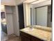 Bright bathroom featuring a granite countertop, a large mirror, and plentiful storage at 14300 E Marina Dr # 106, Aurora, CO 80014