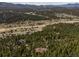Breathtaking aerial perspective of a home nestled amongst the trees at 8724 Armadillo Trl, Evergreen, CO 80439