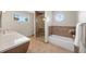 Bathroom with separate walk-in shower and bathtub, plus a vanity with countertop at 8724 Armadillo Trl, Evergreen, CO 80439