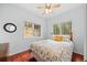 Inviting bedroom featuring hardwood floors, natural lighting, and a ceiling fan at 8724 Armadillo Trl, Evergreen, CO 80439