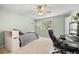 Comfortable bedroom with carpet, complemented by views through two windows, and a ceiling fan at 8724 Armadillo Trl, Evergreen, CO 80439