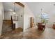 Dining room with high ceilings, tiled floors, chandelier and views of the outdoors at 8724 Armadillo Trl, Evergreen, CO 80439