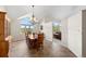 Dining room featuring large windows with views, chandelier, and tiled flooring at 8724 Armadillo Trl, Evergreen, CO 80439