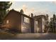Charming two-story home with a two car garage and classic design features at dusk at 8724 Armadillo Trl, Evergreen, CO 80439